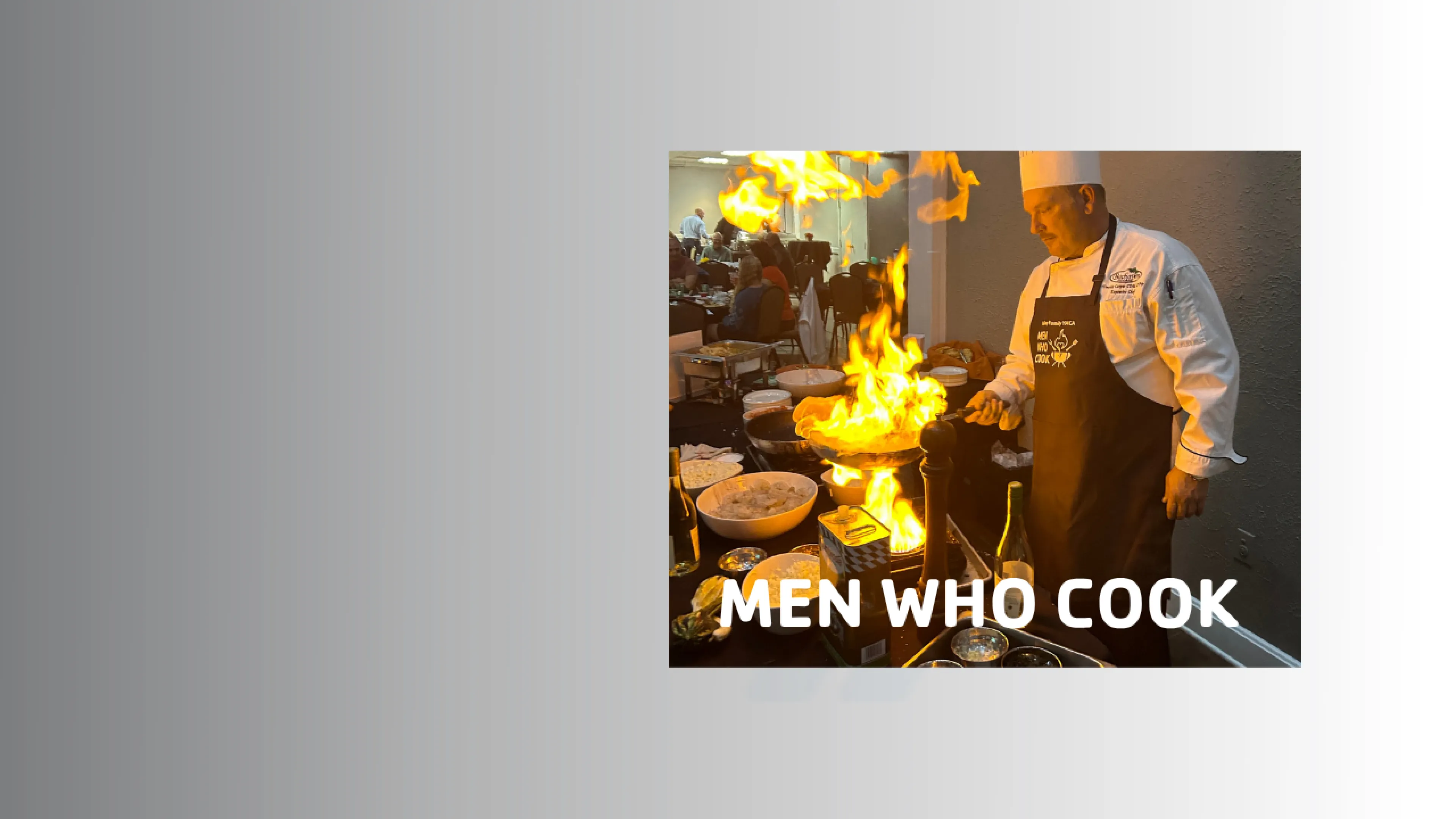 Men Who Cook '26 homepage banner with an image of a chef at the 2026 event cooking a dish with flames emitting from the pan.